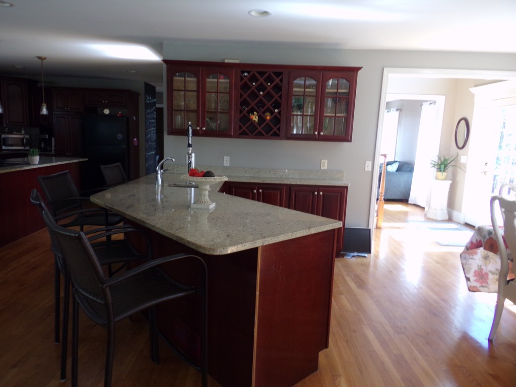 224 Perry Hill Road Acushnet, MA 02743 - Photo 19 of 30 a kitchen with stainless steel appliances granite countertop a sink a stove and wooden floor