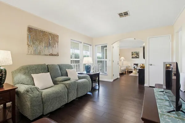 a kitchen with stainless steel appliances granite countertop white cabinets a sink and a window