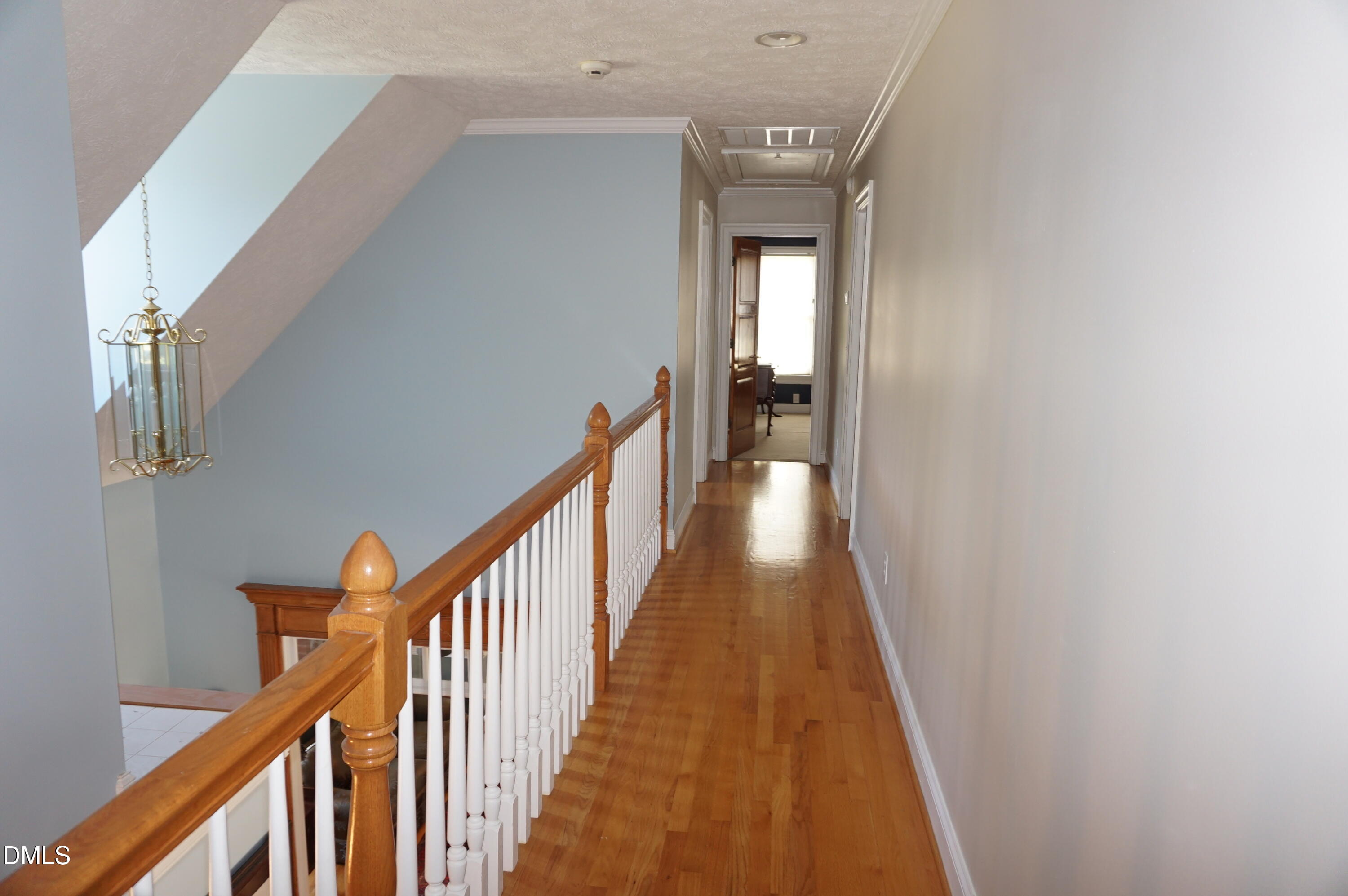2125 Keith Hills Road Lillington, NC 27546 - Photo 40 of 66 a view of a hallway with wooden floor and stairs