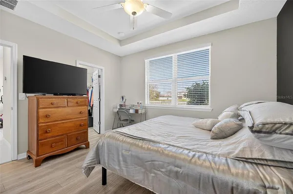 a bedroom with a bed and flat screen tv