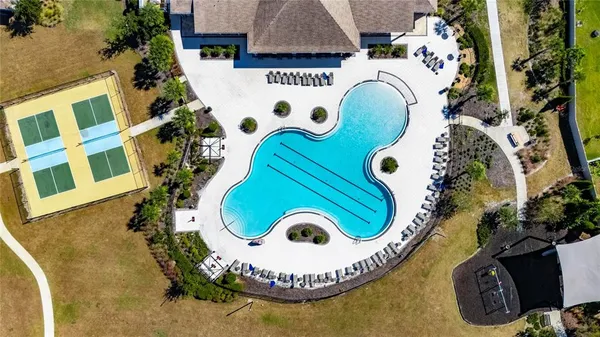 an aerial view of residential house with outdoor space and swimming pool