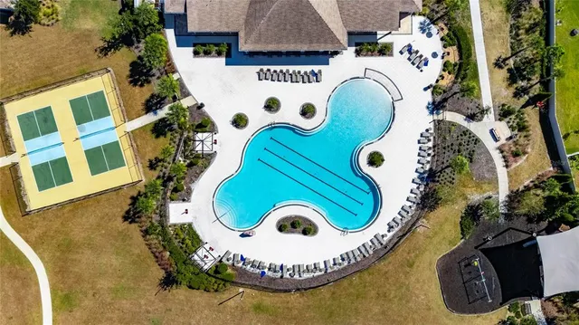 an aerial view of residential house with outdoor space and swimming pool
