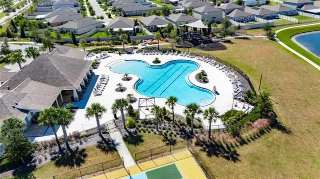 a swimming pool with outdoor seating and yard