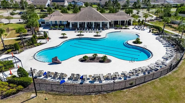 an aerial view of a house with a swimming pool yard and outdoor seating