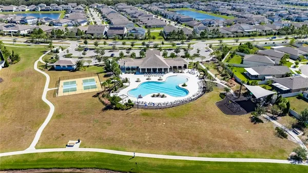 an aerial view of a house with swimming pool and outdoor space