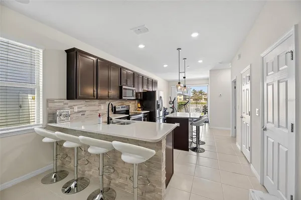 a kitchen with stainless steel appliances kitchen island granite countertop a sink and cabinets