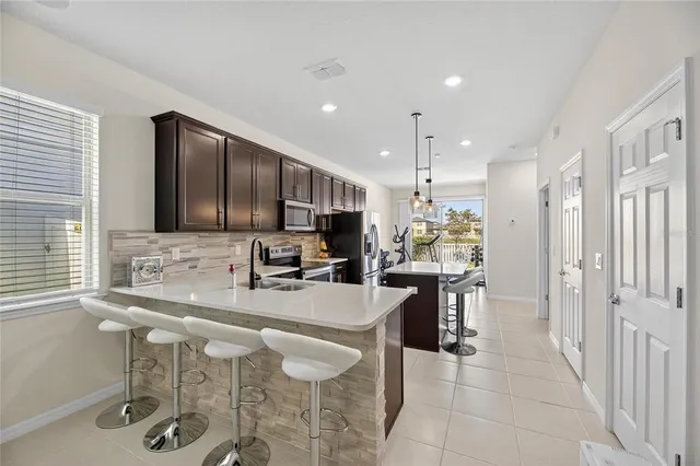 a kitchen with stainless steel appliances kitchen island granite countertop a sink and cabinets