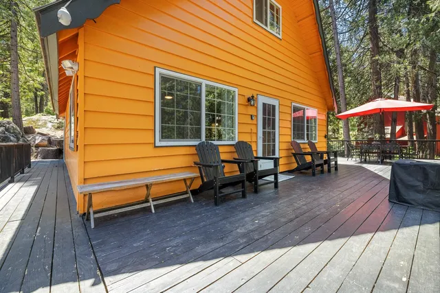 a backyard of a house with barbeque oven table and chairs