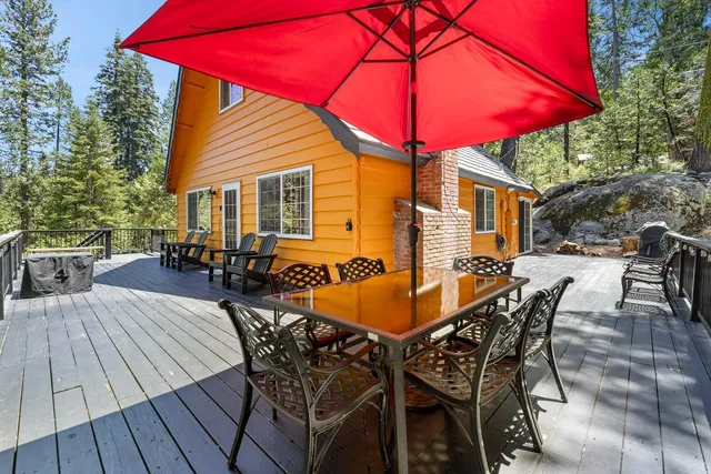 a view of a patio with table and chairs under an umbrella