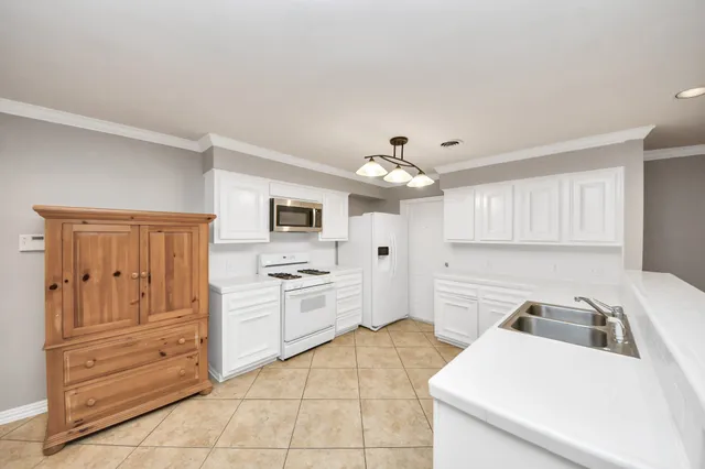 a kitchen with a sink and refrigerator