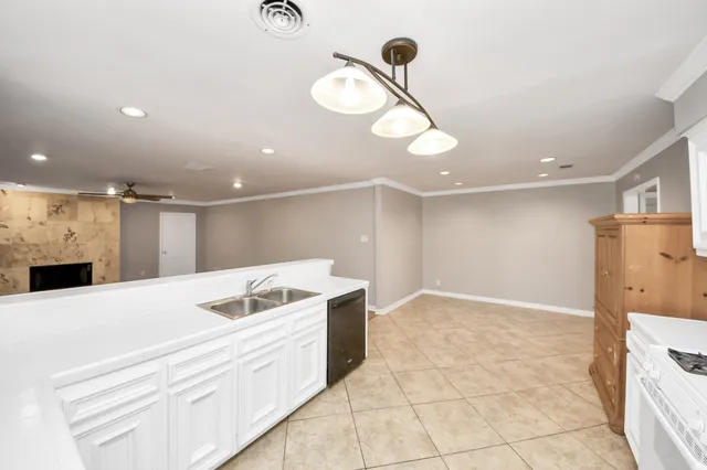 a kitchen with stainless steel appliances kitchen island granite countertop a stove a sink and a refrigerator