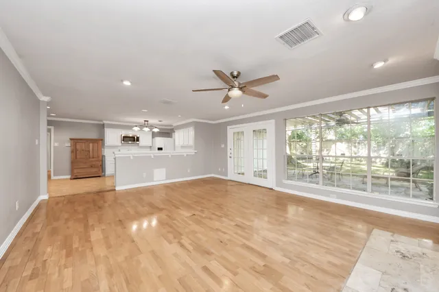 a view of a livingroom with a ceiling fan and window