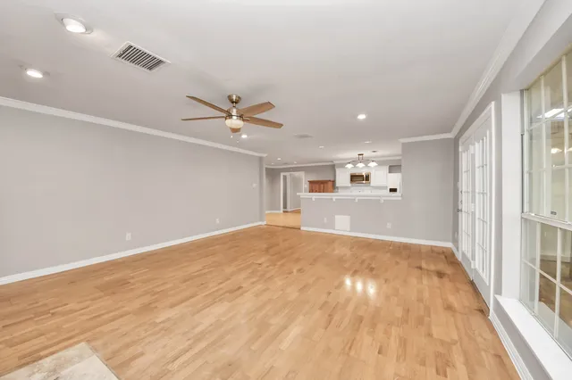a view of an empty room with a fireplace and a window