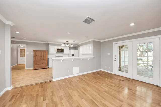 a view of a room with a window and a ceiling fan