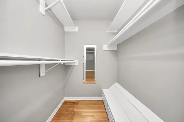 a bathroom with a granite countertop sink a mirror and a shower