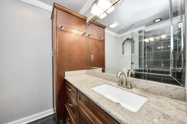 a bathroom with a double vanity sink mirror and shower