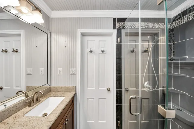 a bathroom with a mirror and shower