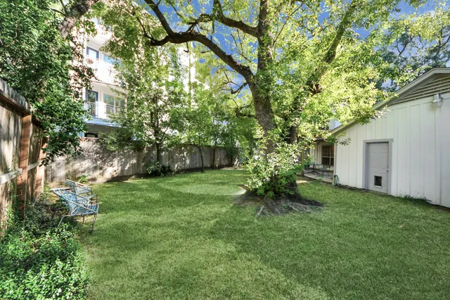 a backyard of a house with table and chairs