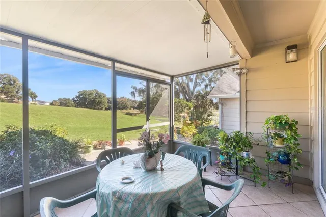 a view of a backyard with table and chairs a barbeque and a yard