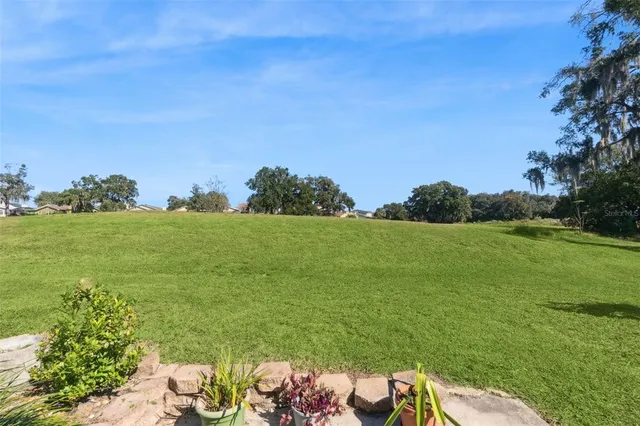 a front view of a house with a garden and yard