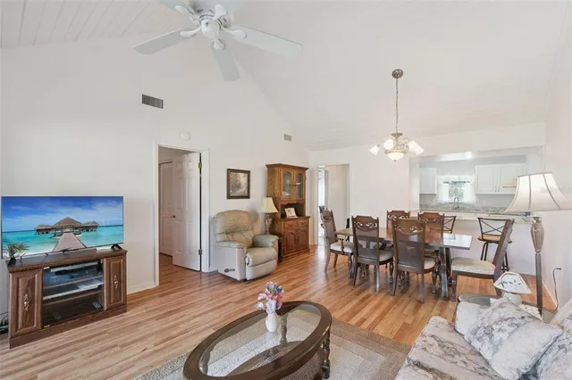 a living room with furniture tv and a floor to ceiling window