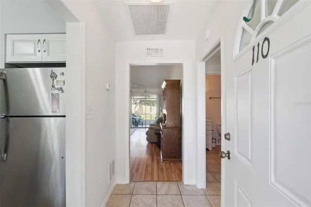 a kitchen with granite countertop white cabinets and a sink