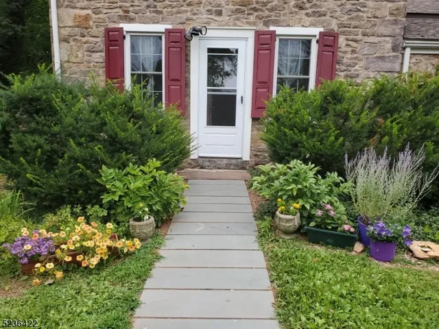 a view of a house with potted plants