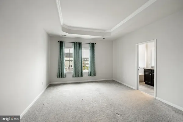 a view of an empty room and closet area