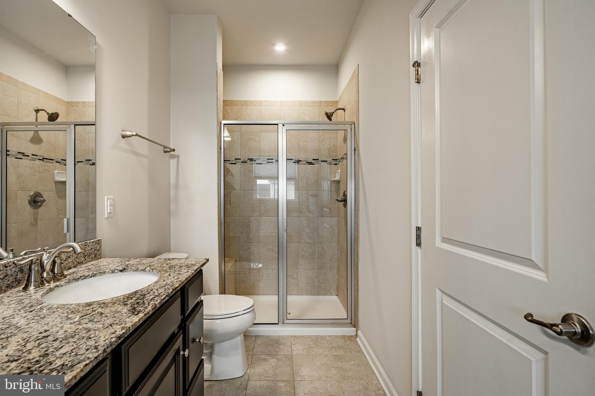 300 Blue Welsh Street Malvern, PA 19355 - Photo 27 of 37 a bathroom with a granite countertop sink toilet and shower
