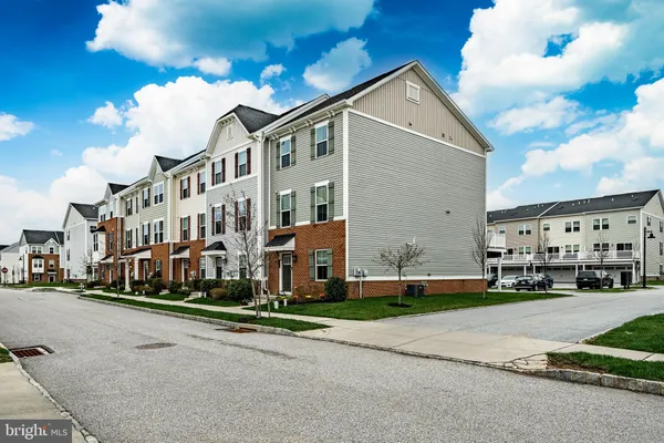 a view of buildings with yard and street view