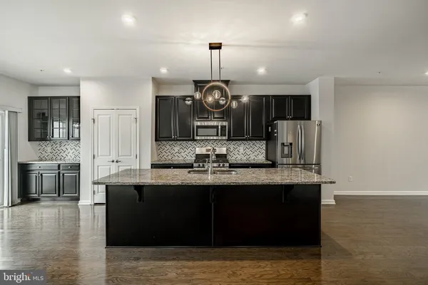a kitchen with center island and stainless steel appliances