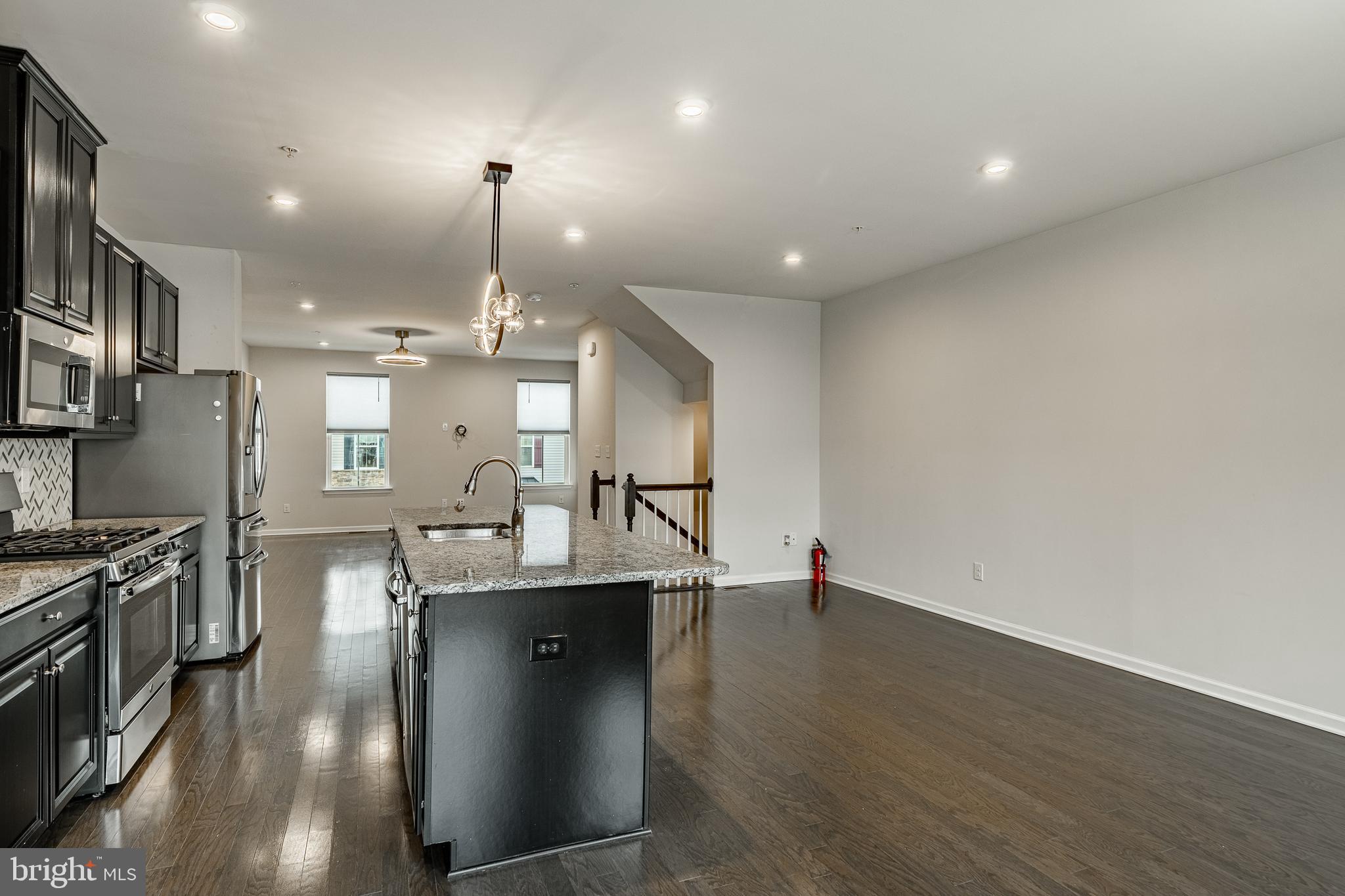300 Blue Welsh Street Malvern, PA 19355 - Photo 6 of 37 a dining room with kitchen island stainless steel appliances furniture a fireplace and a chandelier
