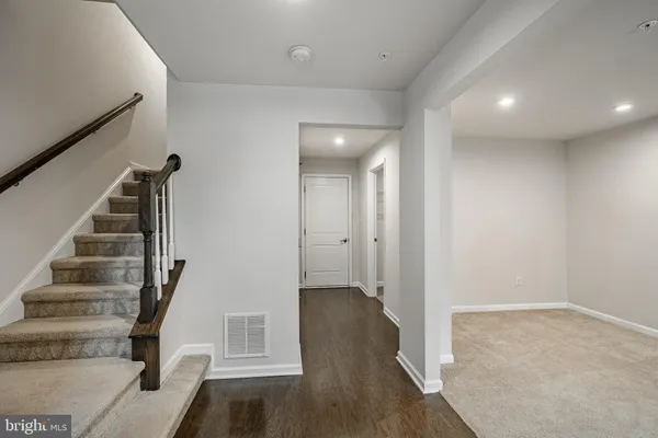 a view of entryway with wooden floor and stairs