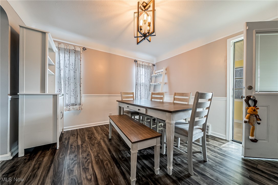 1235 Dorsh Road Cleveland, OH 44121 - Photo 13 of 39 Dining area with dark wood-style floors and a chandelier