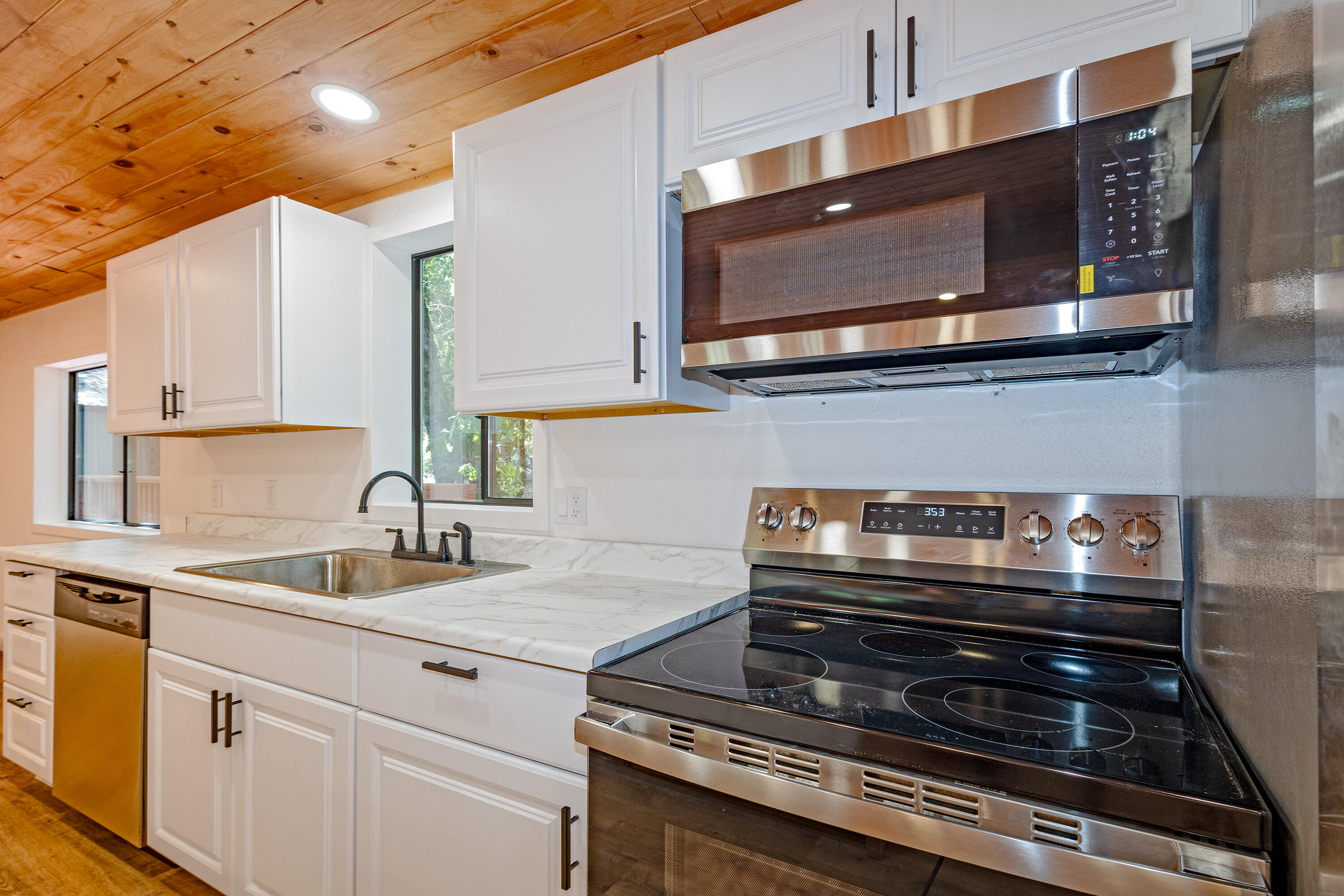 601 Pinewood Way Cave Junction, OR 97523 - Photo 9 of 33 a kitchen with a stove microwave and sink