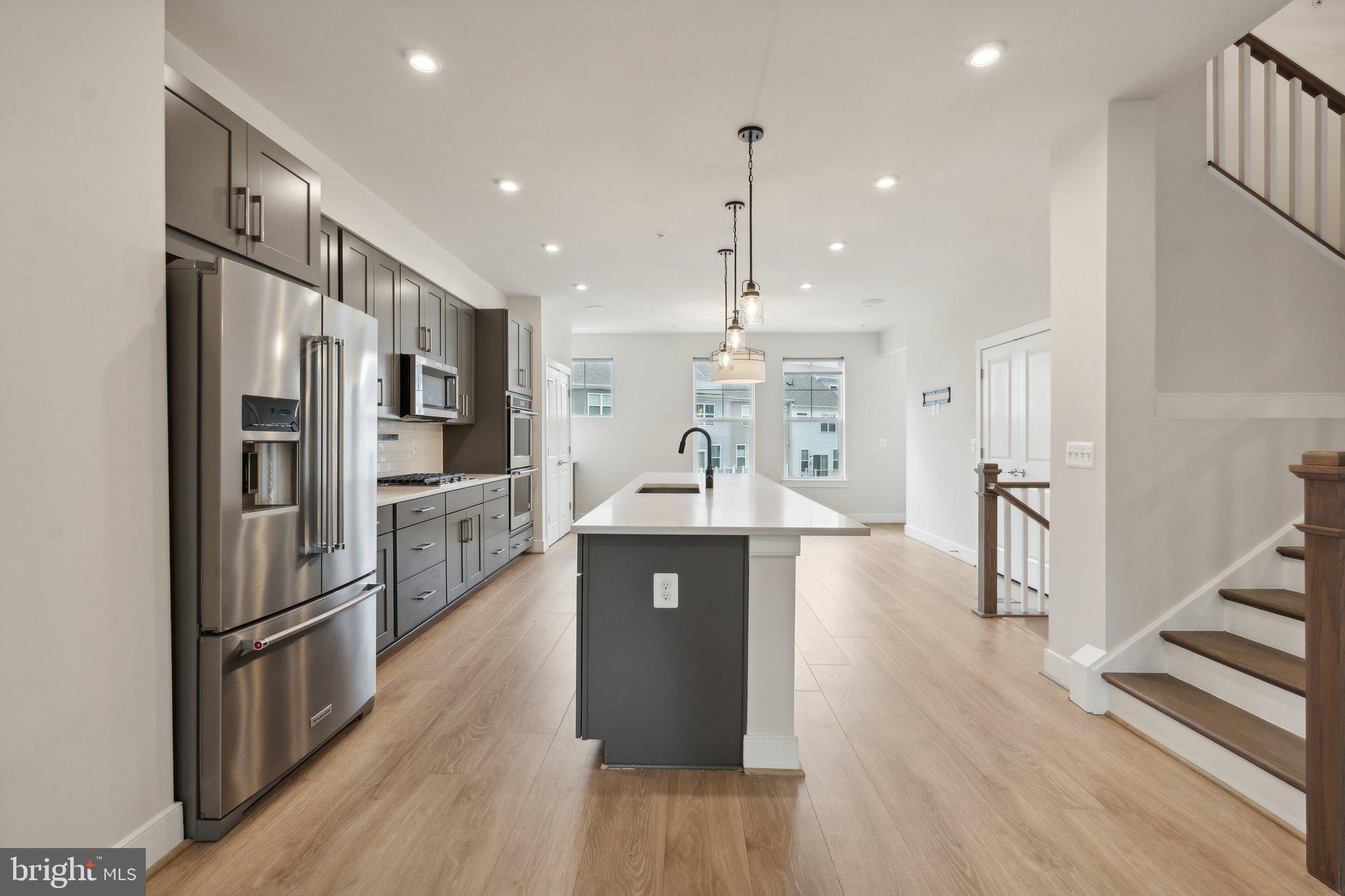 3034 Declan Way Falls Church, VA 22044 - Photo 4 of 41 a kitchen with stainless steel appliances granite countertop a refrigerator a sink dishwasher a oven and white cabinets with wooden floor