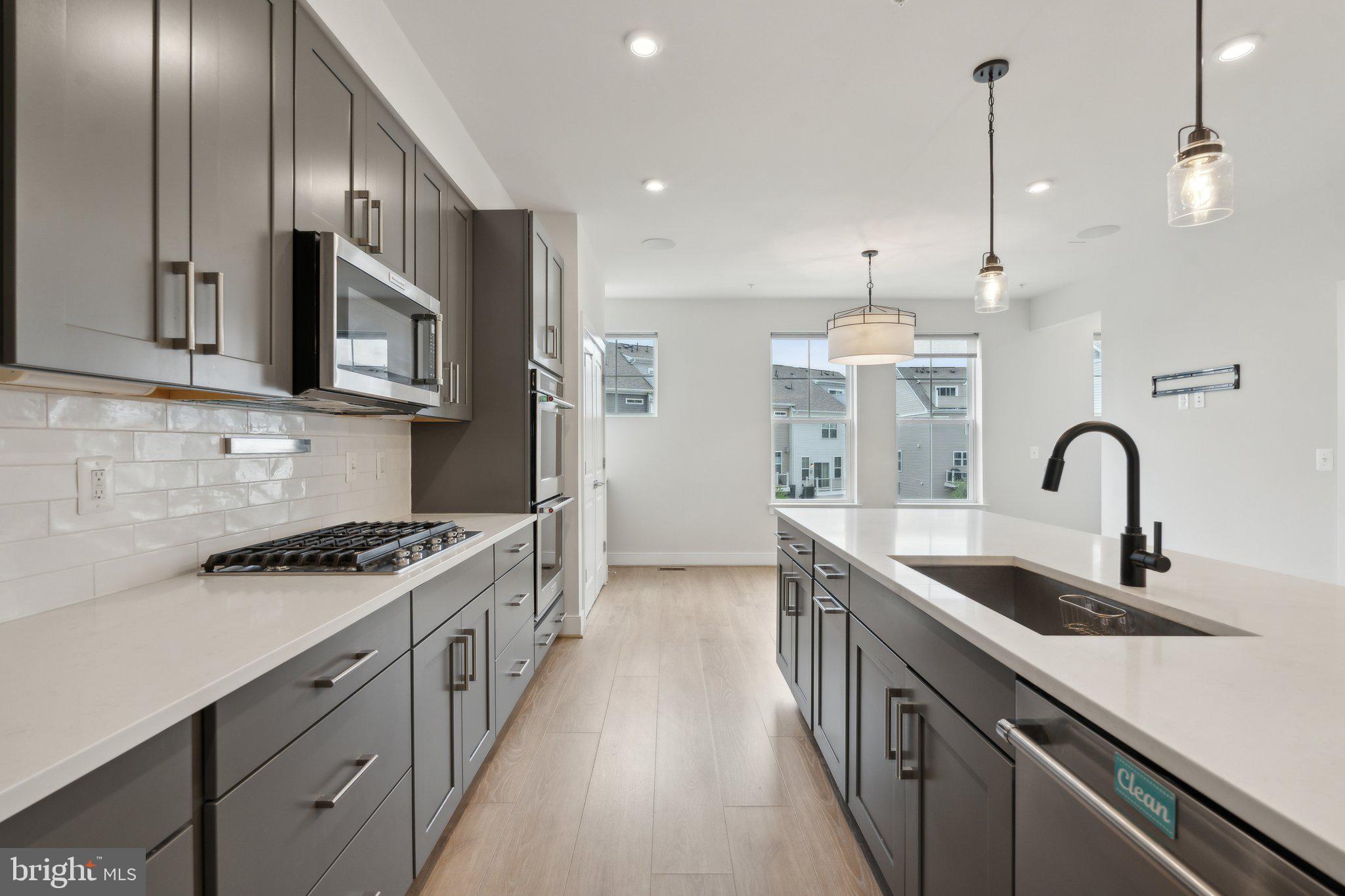 3034 Declan Way Falls Church, VA 22044 - Photo 8 of 41 a kitchen with stainless steel appliances granite countertop a sink a stove and a refrigerator