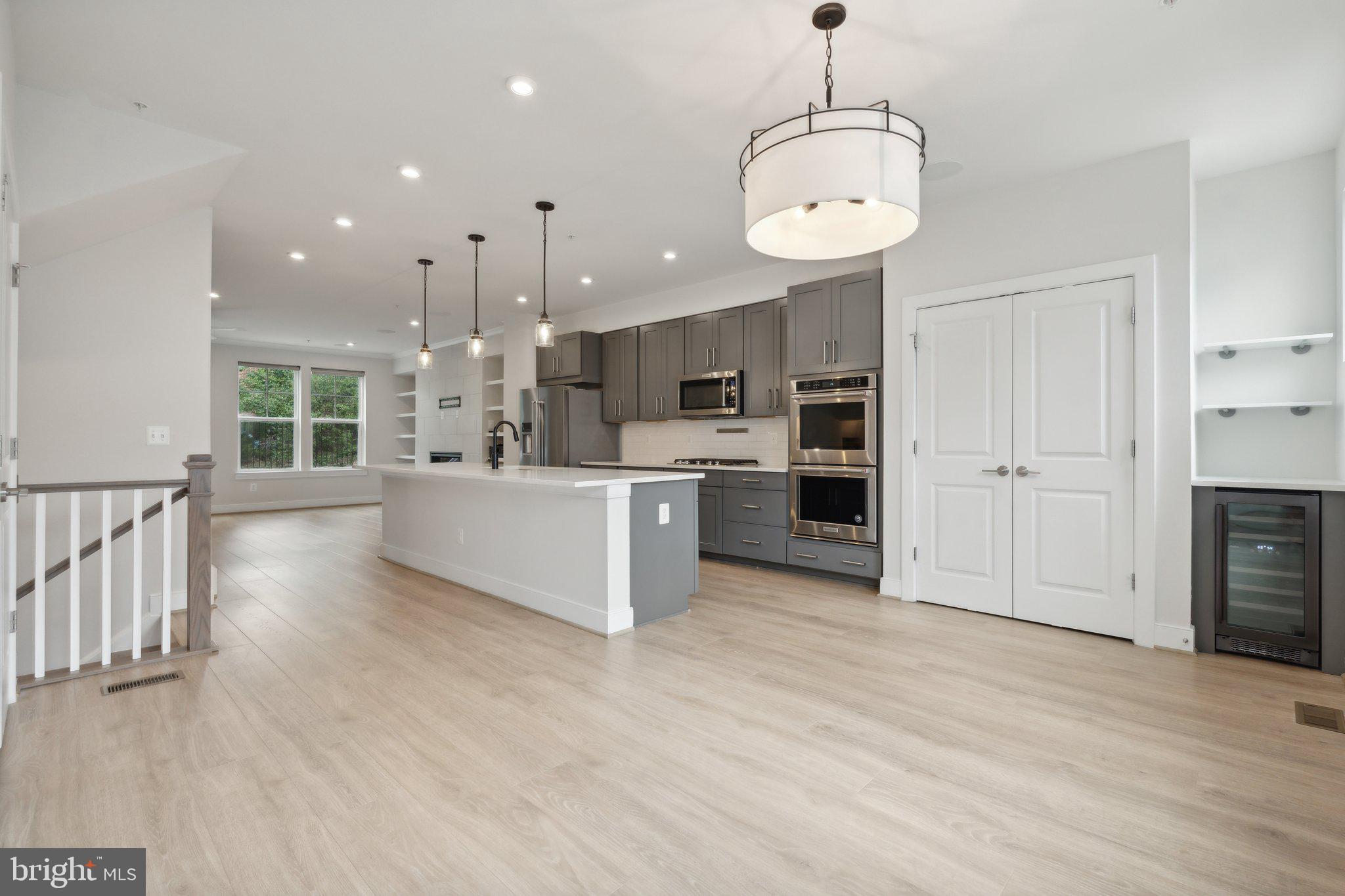 3034 Declan Way Falls Church, VA 22044 - Photo 10 of 41 a large kitchen with kitchen island a sink stainless steel appliances and cabinets