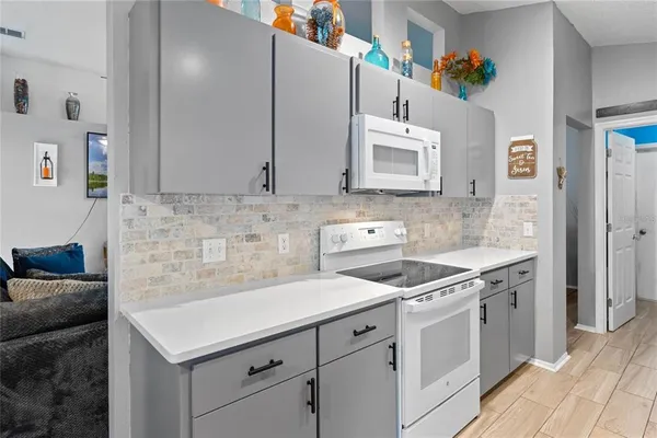 a kitchen with cabinets and white appliances