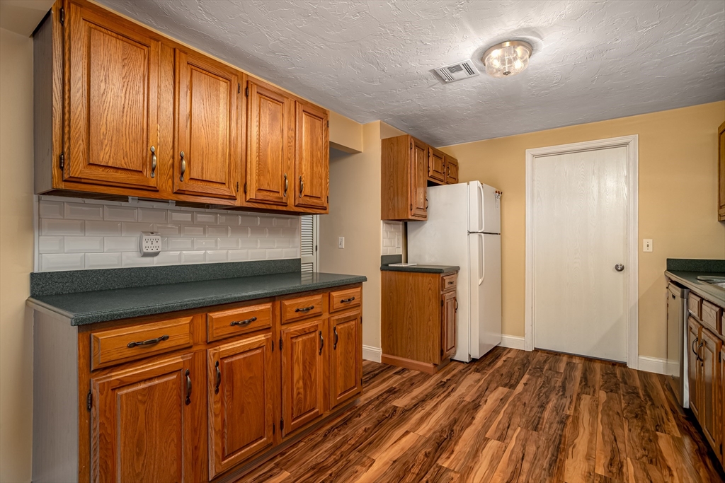 115 Ridgefield Circle, Unit D Clinton, MA 01510 - Photo 12 of 29 a kitchen with stainless steel appliances granite countertop a refrigerator and a sink