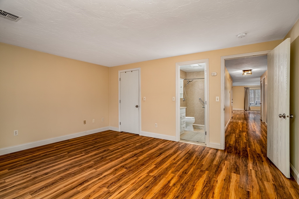 115 Ridgefield Circle, Unit D Clinton, MA 01510 - Photo 13 of 29 a view of a room with wooden floor and a bathroom