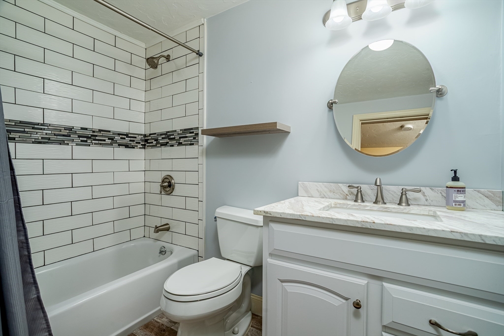 115 Ridgefield Circle, Unit D Clinton, MA 01510 - Photo 20 of 29 a bathroom with a sink a toilet and shower