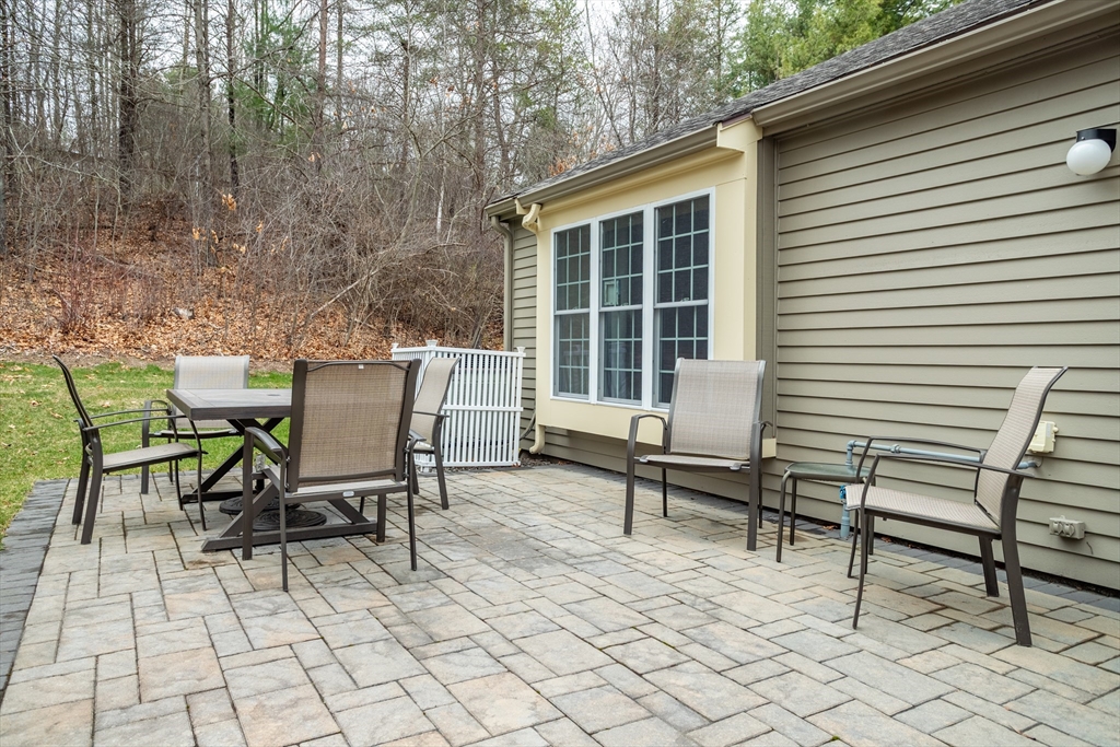 115 Ridgefield Circle, Unit D Clinton, MA 01510 - Photo 21 of 29 a backyard of a house with table and chairs