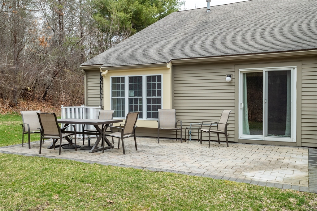 115 Ridgefield Circle, Unit D Clinton, MA 01510 - Photo 22 of 29 a view of a house with backyard and sitting area