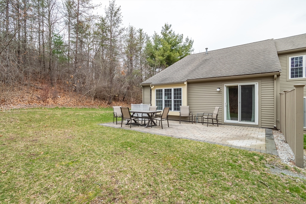 115 Ridgefield Circle, Unit D Clinton, MA 01510 - Photo 23 of 29 a view of a house with backyard porch and sitting area