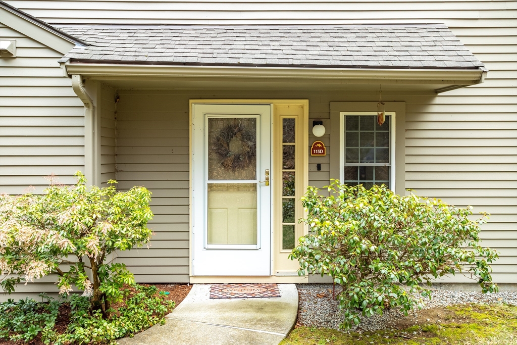 115 Ridgefield Circle, Unit D Clinton, MA 01510 - Photo 3 of 29 a front view of a house with plants
