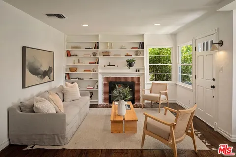 a living room with furniture fireplace and window
