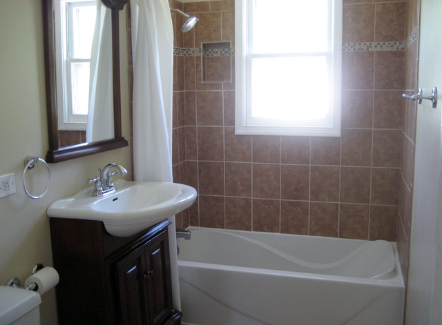 582 Riedy Road Lisle, IL 60532 - Photo 5 of 23 a white bath tub sitting next to a white sink
