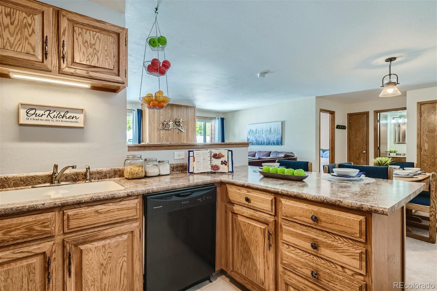 89100 Ryan Gulch Road, Unit 206 Silverthorne, CO 80498 - Photo 3 of 17 a kitchen with stainless steel appliances granite countertop a sink and cabinets