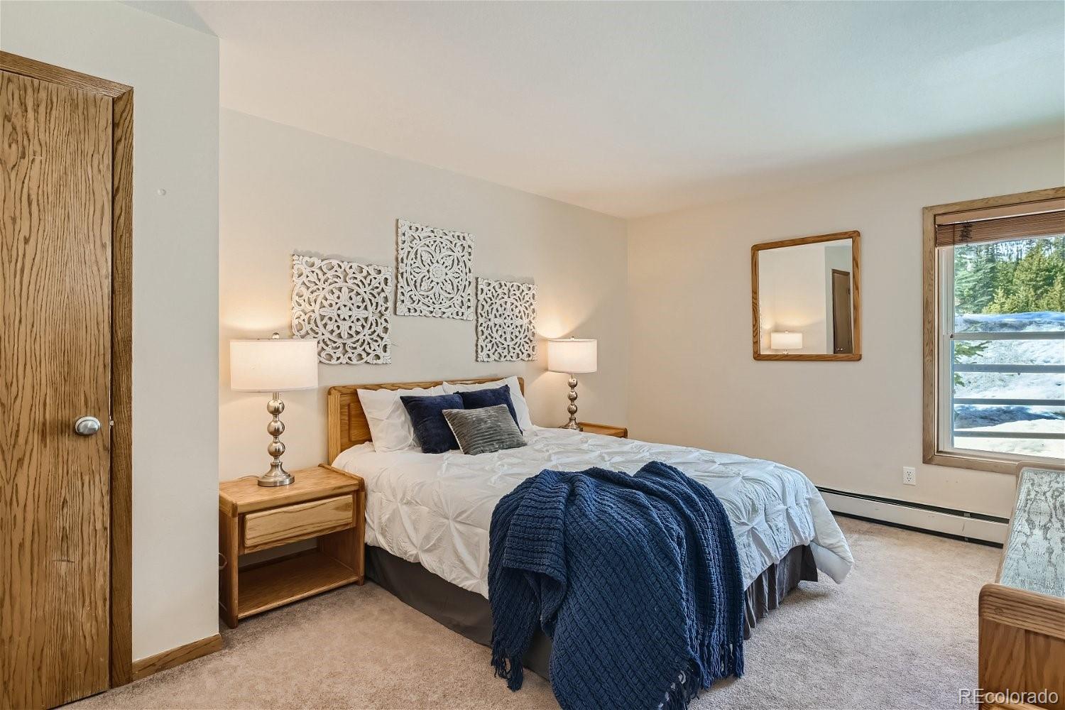 89100 Ryan Gulch Road, Unit 206 Silverthorne, CO 80498 - Photo 5 of 17 a bedroom with a bed and a window